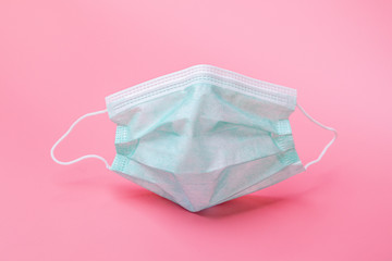 Medical mask on the pink background.