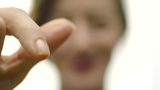Woman holds bouillon cube to camera, then drops it