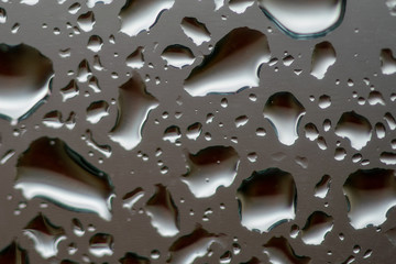 close up water droplets on a piece of glass 