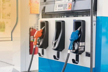 Gas stations are colorful, fill different nozzles. Gas stations adjust the oil prices down a lot.