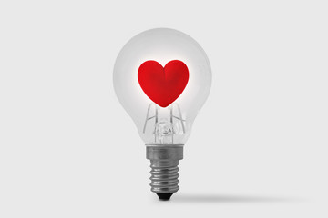 Light bulb with heart on white background - Concept of love and brain