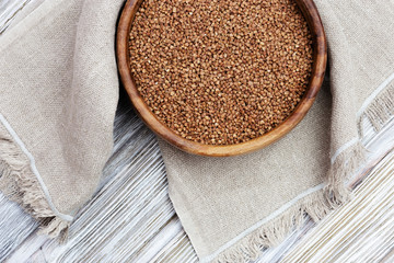 Appetizing buckwheats. Full plate with buckwheats on wooden background with copy space. Healthy eating. Rustic style.