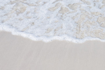 Ocean waves on the sandy beach for background, concept of the beach in the summer