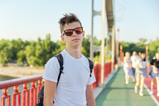Teen boy 15 years old with fashionable hairstyle sunglasses looking