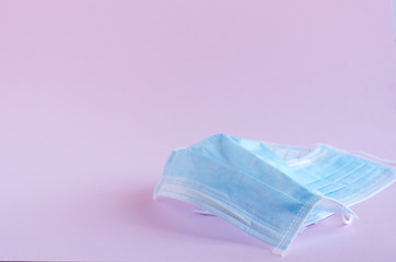 Fototapeta premium Medical masks on a pink background. Soft focus, horizontal image.