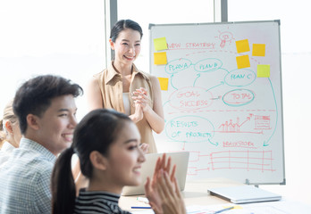 Fototapeta premium Happy Asian business clapping hands after business meeting successful in modern office, multi raced worker group conference success project happy agreement and contact, business and financial concept.