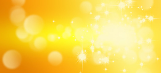 Abstract blurry image of light and golden bokeh background.