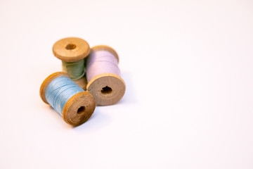 Three spools of thread on a white background