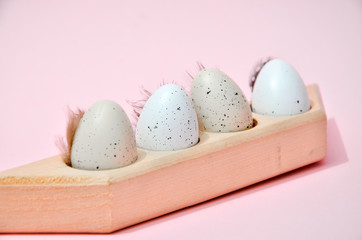 eggs in a wooden box on pink background