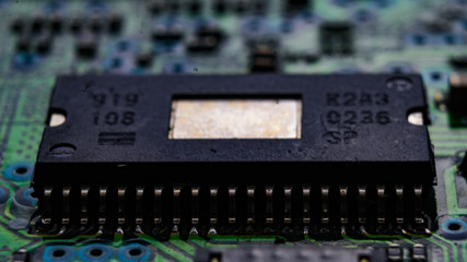 Macro shot of a black computer chip on a circuit board.