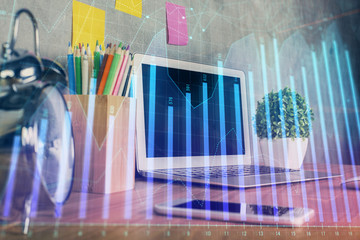 Financial chart drawing and table with computer on background. Double exposure. Concept of international markets.