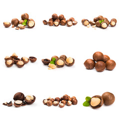 Macadamia nut with pieces and green leaves isolated on a white background