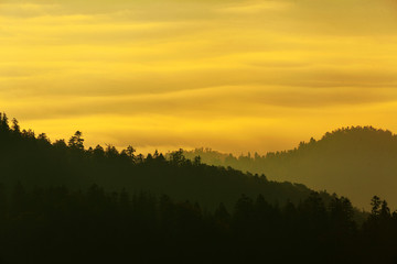 Sunset on the mountain with the layers of the hills