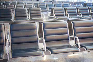 Fototapeta premium Waiting room at the airport with empty seats. The empty hall of the airport during an outbreak of the virus COVID-19 Pandemic virus