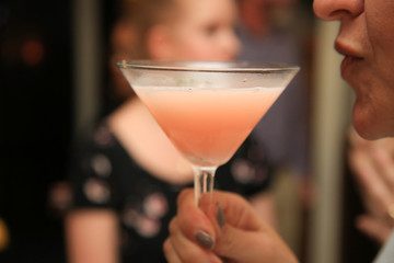 Cocktail in a hand. Cocktail of delicate color. Сocktail party.