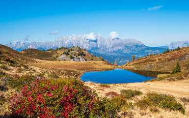 Autumn alpine Kleiner Paarsee or Paarseen lake, Land Salzburg, Austria. Alps Hochkonig rocky mountain group view in far.