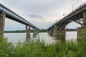 Railway and road bridge over a large river. Two bridges