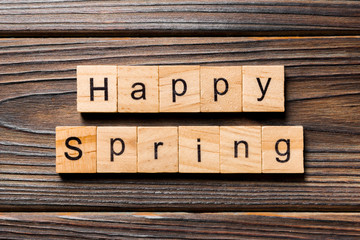 Happy Spring word written on wood block. Happy Spring text on wooden table for your desing, concept