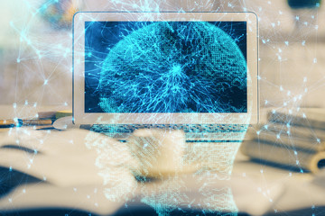Double exposure of work space with computer and human brain drawing hologram. Brainstorm concept.