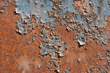 Rusty metal surface with flaking old dark paint