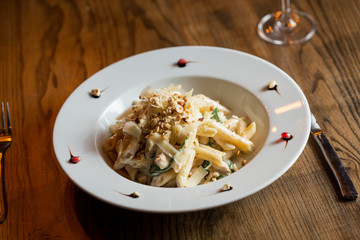 Penne with chicken, spinach and hazelnut in parmesan sauce