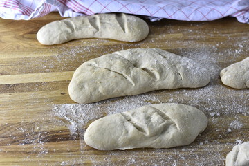 Fresh bread dough on a wood background