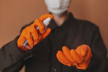 Close-up of hands applying hand sanitizer against coronavirus. Antiseptic spray to prevent spread of germs, bacteria, coronavirus and virus COVID-19. Antiseptic and sanitizer. 