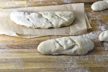 Fresh bread dough on a wood background