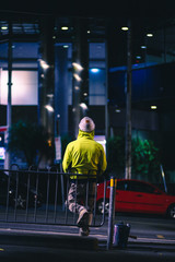Construction Worker in High Visibility Jacket waiting at Tram Stop Melbourne CBD