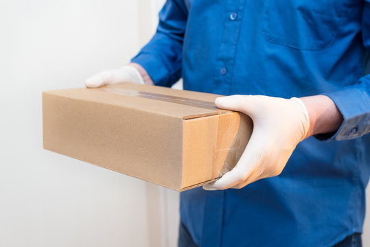 courier man delivers the package to the door, contactless delivery