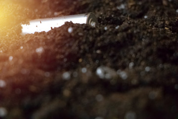 Used batteries in the ground. Hazardous waste polluting the environment. The concept of environmental protection and the recycling of batteries and batteries