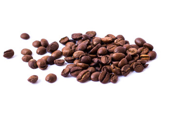 Roasted scattered coffee beans on white background