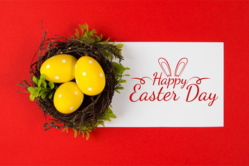 Yellow Easter eggs in a bird's nest on a red background