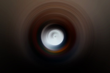 White light at end of tunnel. Bright circle on black background.