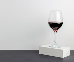 Glass of red wine on a white background. Minimalism. Design. Mock-up. Copy space.
