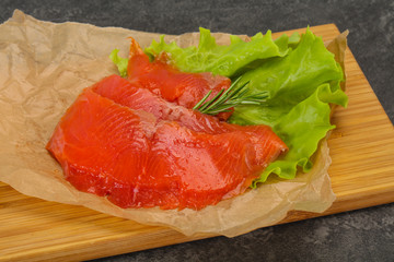 Sliced salmon fillet served rosemary
