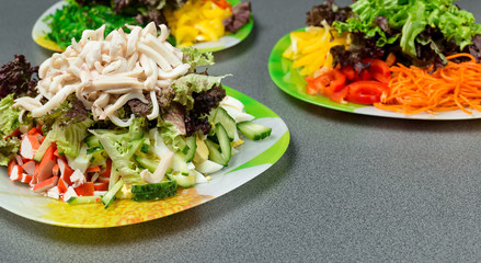 Ingredients for making salad on a green plate.