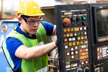 Fototapeta na wymiar Electrician Engineers repairing machinery in industrial plants. worker Working at the Heavy Industry Manufacturing Facility.