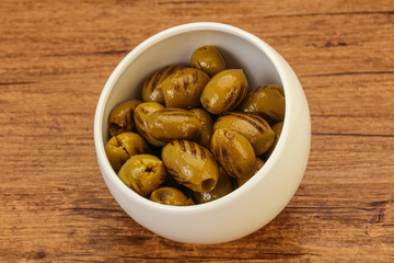 Green grilled olives in the bowl