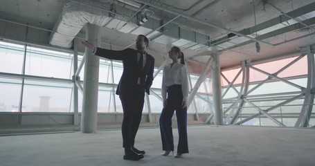 Two entrepreneurs examining commercial space for office