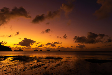 Sunset on the tropical beach. Orange sunset on the ocean. Colorful sunset in the tropics