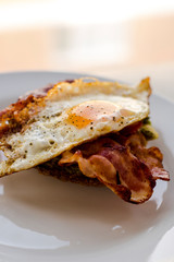 close up of avocado toast for breakfast with fried egg