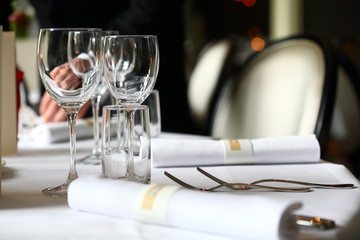 empty wine glasses on a row and on a decorated table