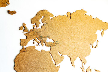 A cork world map wall decoration with pins that mark places visited, routes traveled or travel plans