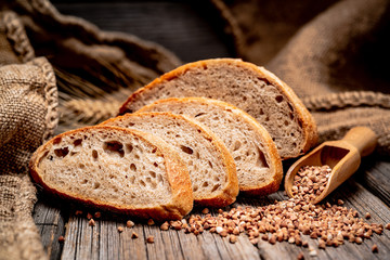 Freshly baked traditional bread on wooden table.