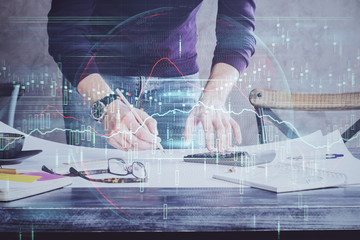 Multi exposure of man standing and planing investment with stock market forex chart.