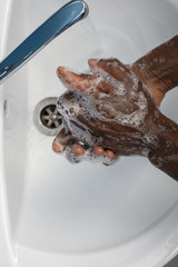 Man washing hands carefully with soap and sanitizer, close up. Prevention of pneumonia virus spreading, protection against coronavirus pandemia. Hygiene, sanitary, cleanliness, disinfection. Safety.