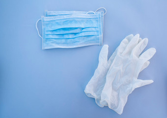 medical disposable mask and white gloves on a blue background.  items of protection against coronavirus and other viruses