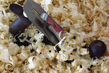 An old wood plane amongst pine shavings