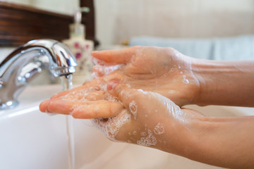 Fototapeta premium Women who wash their hands with gel or disinfectant with antibacterial soap after using the bathroom. Hygiene concept. prevent the spread of germs and bacteria and prevent corona virus infections